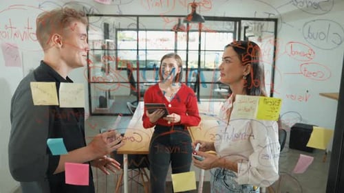 Creative Team Brainstorming Ideas at Office Whiteboard