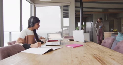 Young Woman Studying at Home with Laptop