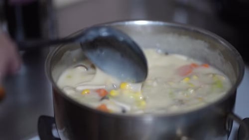 Delicious Vegetable Soup Simmering in Stainless Steel Pot