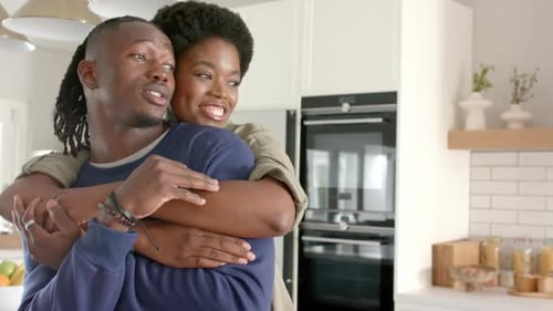Happy Couple Embracing in Modern Kitchen