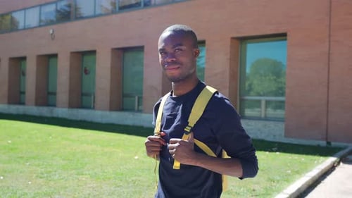 Young happy student smiling at university campus in slow motion