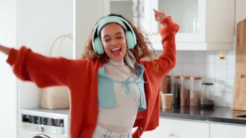 Woman Dancing and Cooking with Headphones at Home