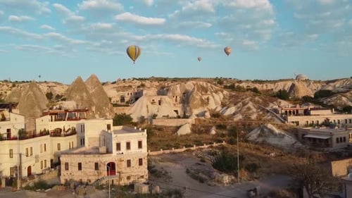 Balloons flying above Goreme at sunrise in Cappadocia, Turkey