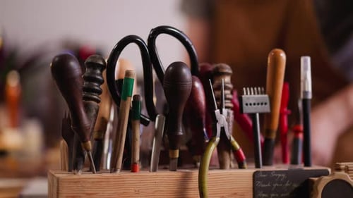 Traditional Tools for Leather Processing on Wooden Rack