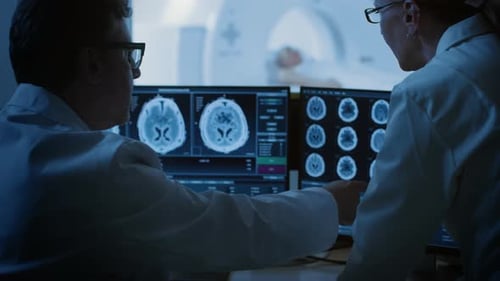 Doctors Reviewing Brain Scans in a Hospital Office