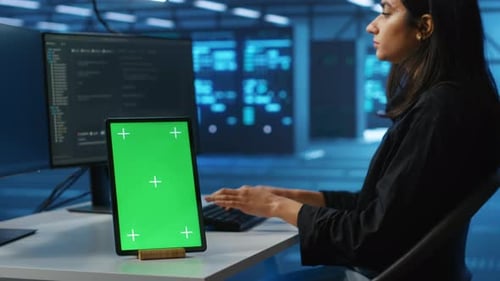 Chroma Key Device on Desk Used By Worker Supervising Data Center Supercomputers