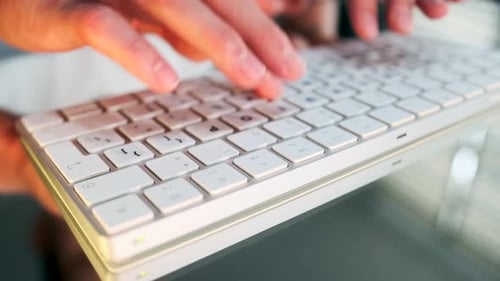 Fingers Typing on White Keyboard Close Up