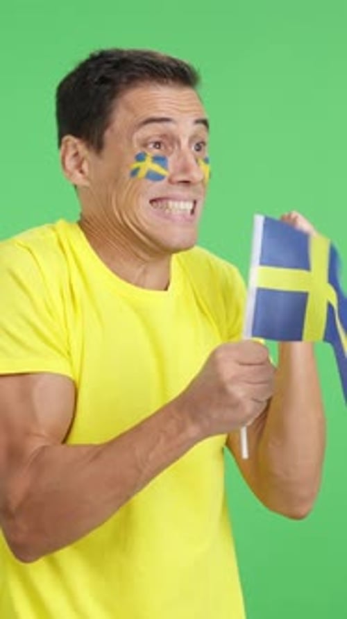 Nervous Man Cheering for Sweden During a Match Looking Away