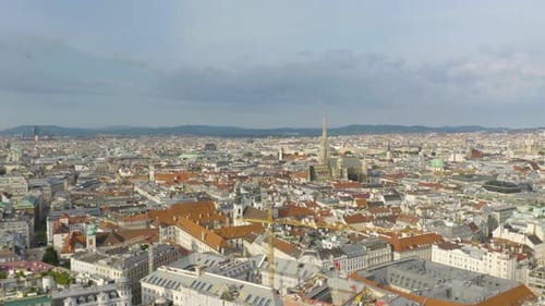 Aerial drone shot moving towards St. Stephen's Cathedral surrounded residential houses and office bu