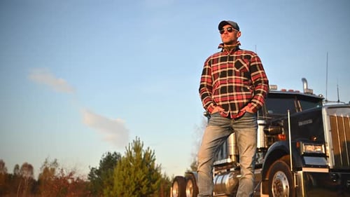 Trucker Standing by Semi-Truck in Rural Area