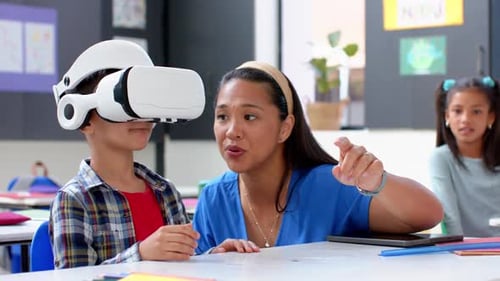 In school, teacher guiding student using VR headset in classroom activity