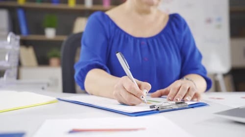 Woman Analyzes Data Graphs in Bright Office