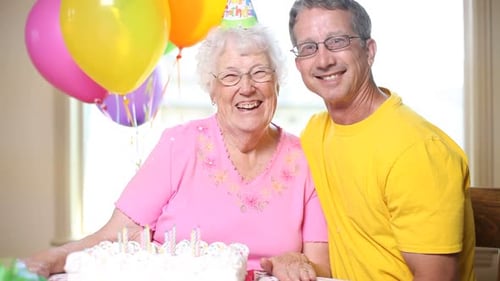 Happy Senior Woman Celebrating Birthday with Adult Son