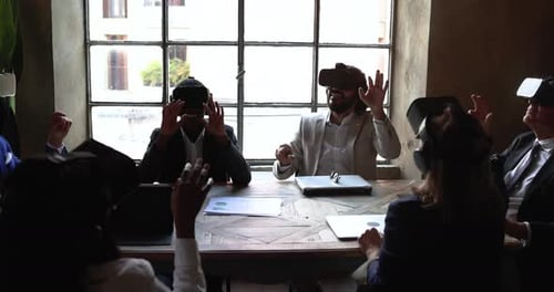 Business people wearing virtual reality goggles inside office