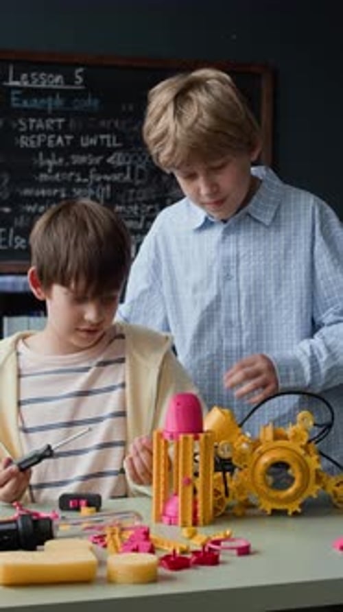 Schoolboys Assembling Robotic Toy Model in Stem Science Class