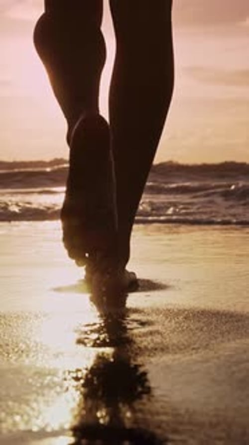 Beautiful Legs of Young Woman Walking on Beach Sand to Summer Sea or Ocean Water