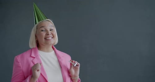 Woman Celebrates Birthday with Party Horn Indoors