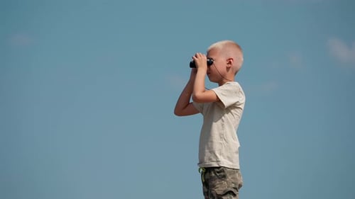Boy Using Binoculars Looking at Clear Blue Sky