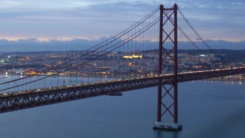 Bridge of 25th April with car traffic after sunset