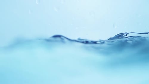 Raindrop Creating Ripples in a Calm Sea. Fluid Motion Captured in Stunning Detail.