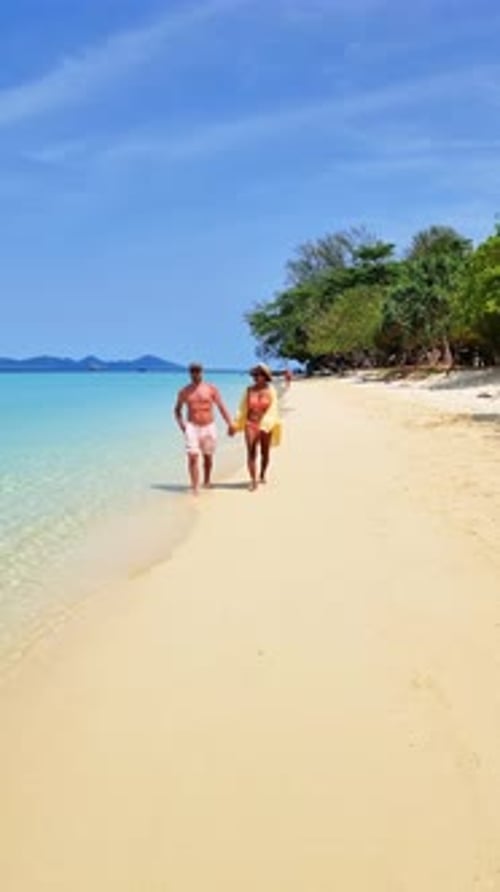 Couple Strolling Beach Hands Intertwined Admiring Horizon and Sky Koh Kradan Thailand