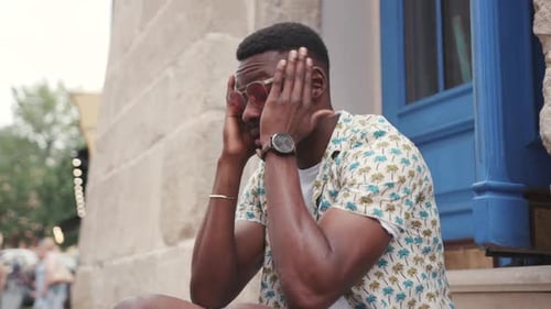 Pleasantlooking African Guy Touching Head Likably Young Man Looking Tired Portrait of Student