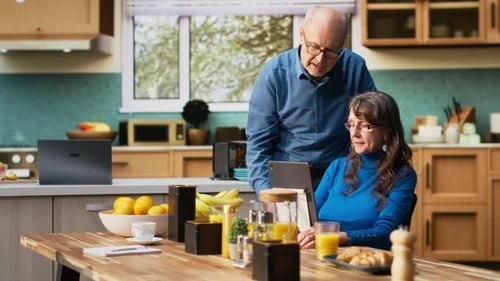 Senior Couple Looking at Tablet in Kitchen