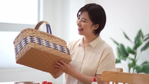 Woman Smiles Holding Finished Woven Basket