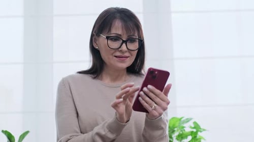 Woman Using Smartphone Indoors During the Daytime