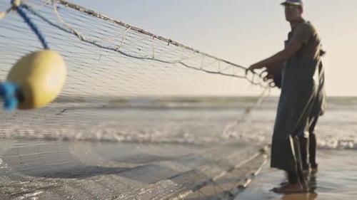 A Man Fisher is Fishing with a Yellow Buoy on a Blue Rope