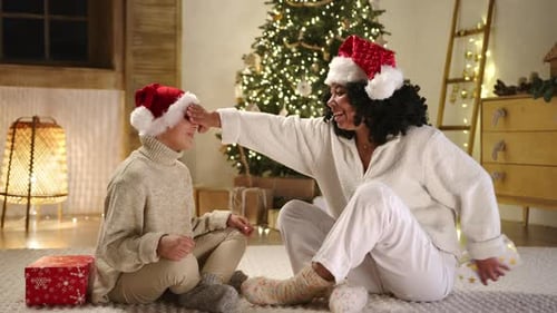 Woman and Child Exchanging Christmas Gifts at Home