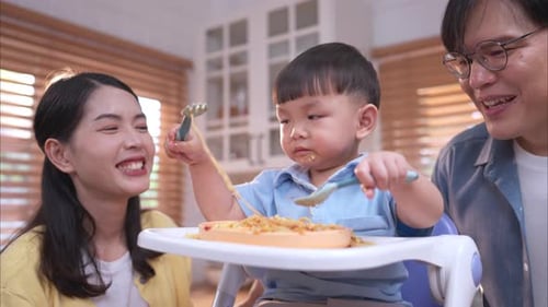 Happy Family Eating Noodles Together at Home