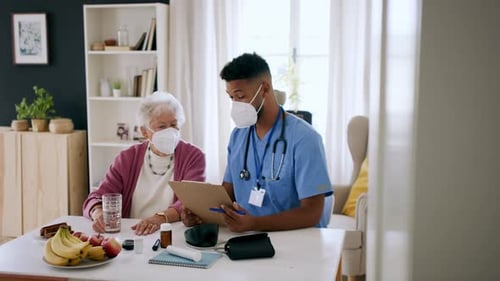 Senior Woman and Medical Worker Reviewing Medication