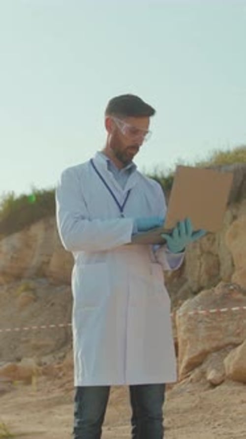 Scientist Examines Desert Research Site with Clipboard