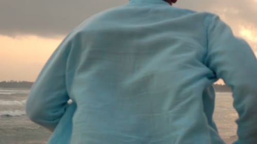 Young Man Running on Beach During Sunset Super 240