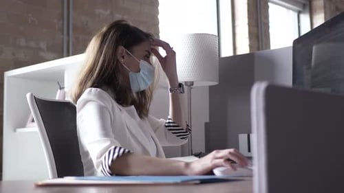 Businesswoman in Face Mask Working at Computer in Office Adult
