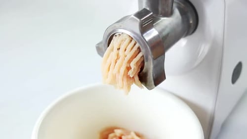 Cooking minced meat in an electric meat grinder from. The process of grinding meat