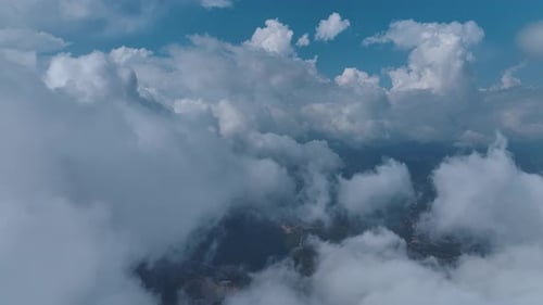 Aerial View CloudCovered Mountain Range and a Quiet Forest Below