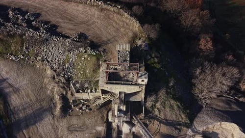 A quarry site has heavy machinery working on extracting minerals