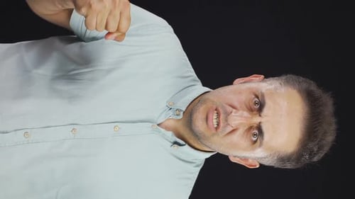Vertical video of Man getting angry at camera.