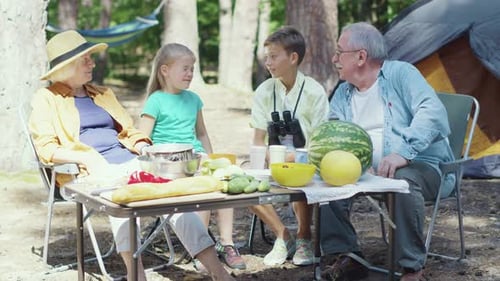 Grandparents and Grandchildren Camping in the Forest