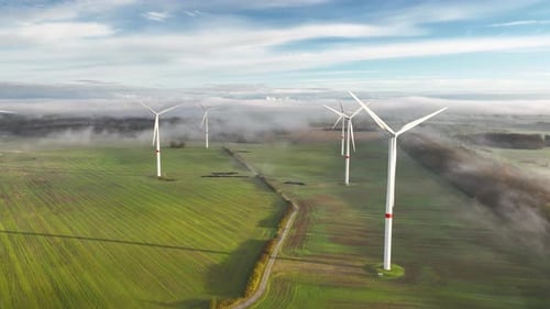 Footage of wind turbines on a wind farm, set against agricultural land and the morning countryside l