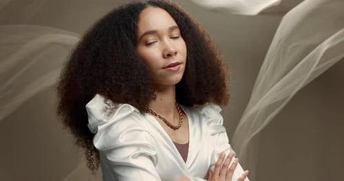 Face, fashion and woman with arms crossed in studio isolated on a gray background