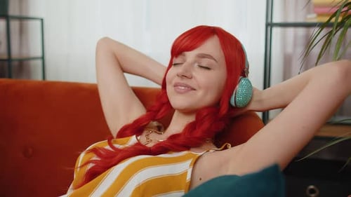 Woman Relaxing on Couch With Headphones