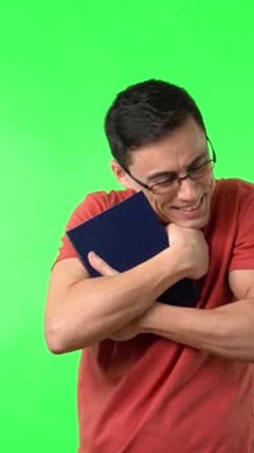 Man Hugging a Book on a Green Background