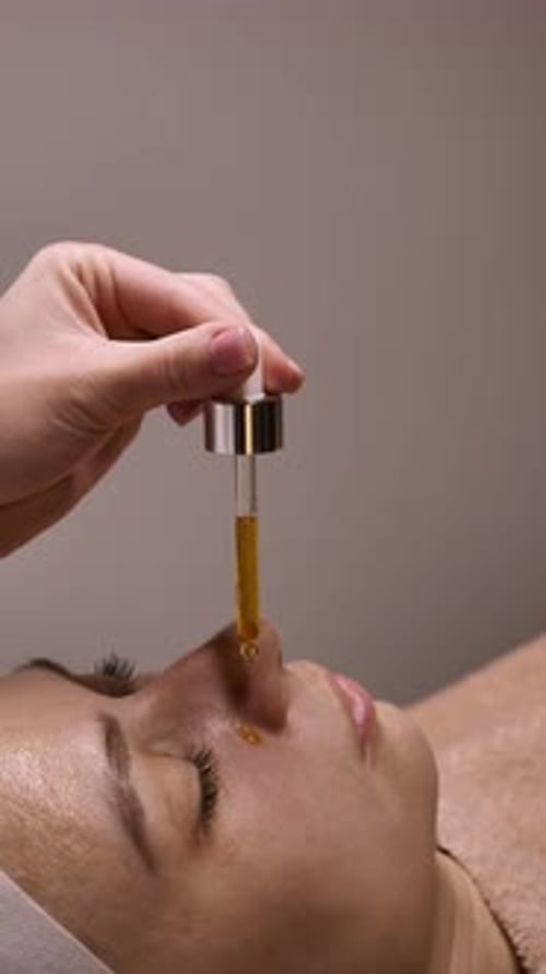 Adult Receiving Facial Treatment with Serum