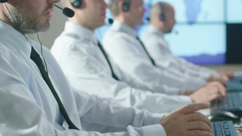 Team of Customer Support Professionals in Call Center Office