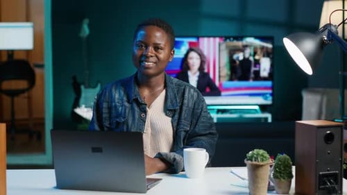 Portrait of Happy Woman Sitting at Home Office Desk in Front of Laptop