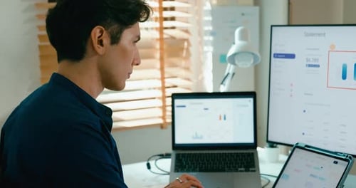 Male use computer remote working on desk in living room at home office.