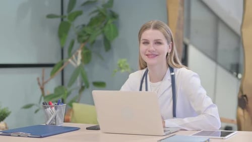 Female Doctor Working at Laptop in Office